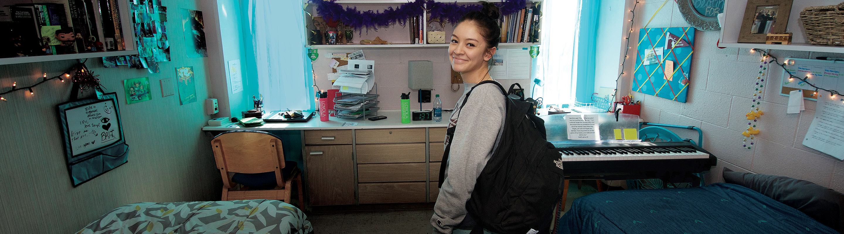 Girl in dorm with keyboard and decorations