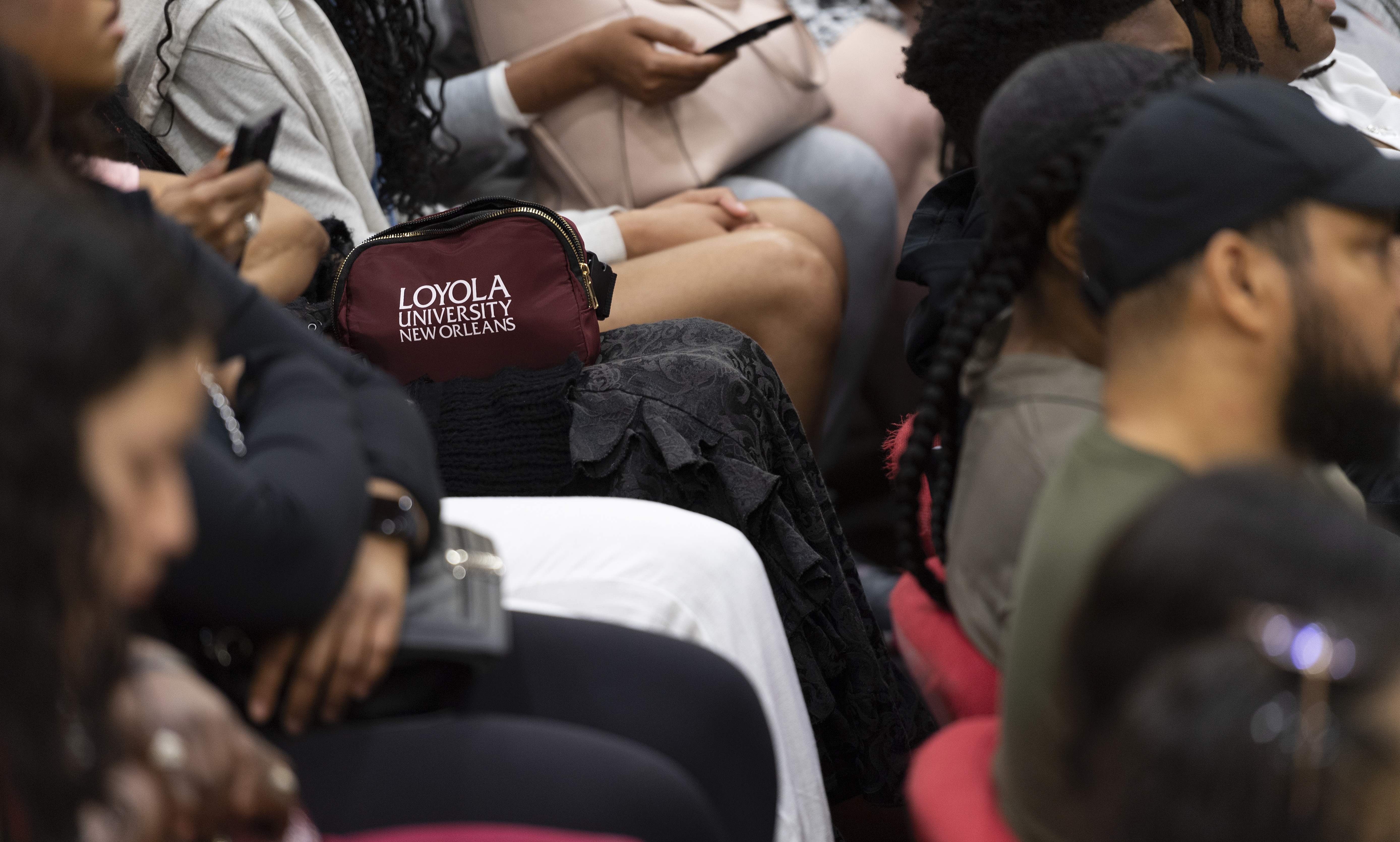 A shot of a Loyola University bag among students sitting for an assembly